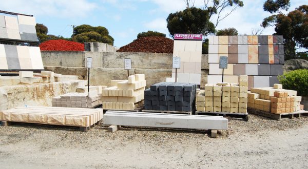 Wide range of pavers and retaining wall blocks in piles at Goolwa Garden Supplies.